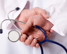 Hands of practitioner with stethoscope
